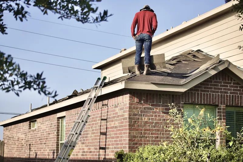 Professional roofer working on a residential roof in Linfield